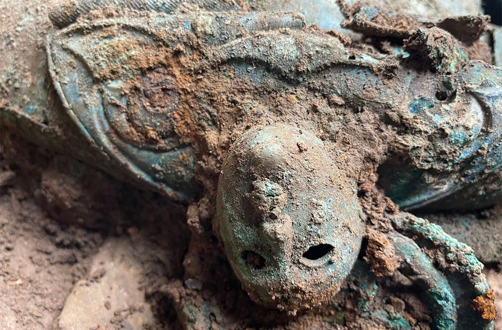 A close-up of a face decoration on an Iron Age bowl