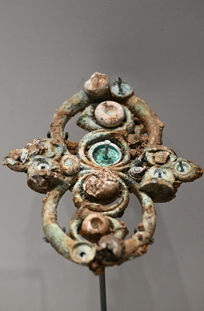 A piece of Iron Age metalwork with remnants of bead and coral decoration