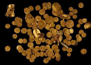 Many gold coins on a black background