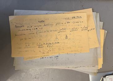 A pile of handwritten mathematical notes
