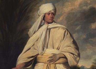 The Portrait of Mai showing detailed face, wearing a traditional-style cream tapa cloth and a turban, showing tattooed hands. Pictured against a warm tropical background. 